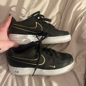 Nike Black Sneakers with Gold Detailing